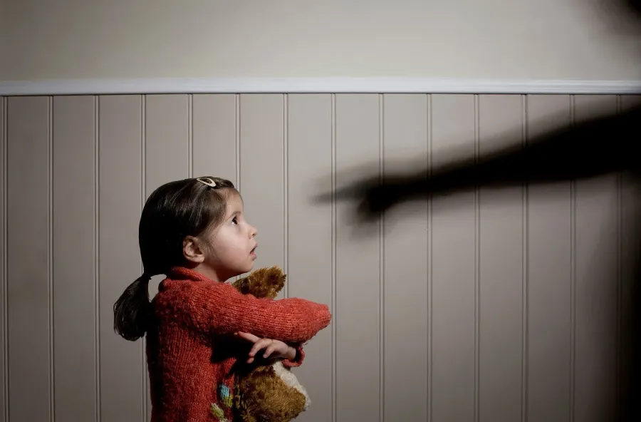 Young girl holding a teddy bear