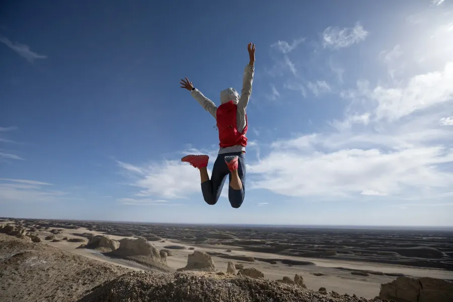 Person jumping joyfully outdoors