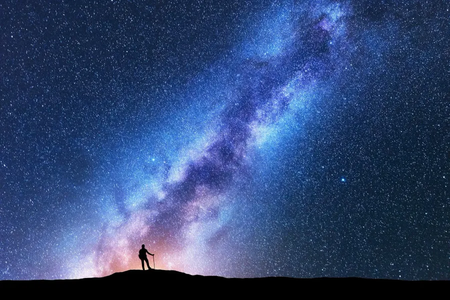 Hiker silhouette under the Milky Way